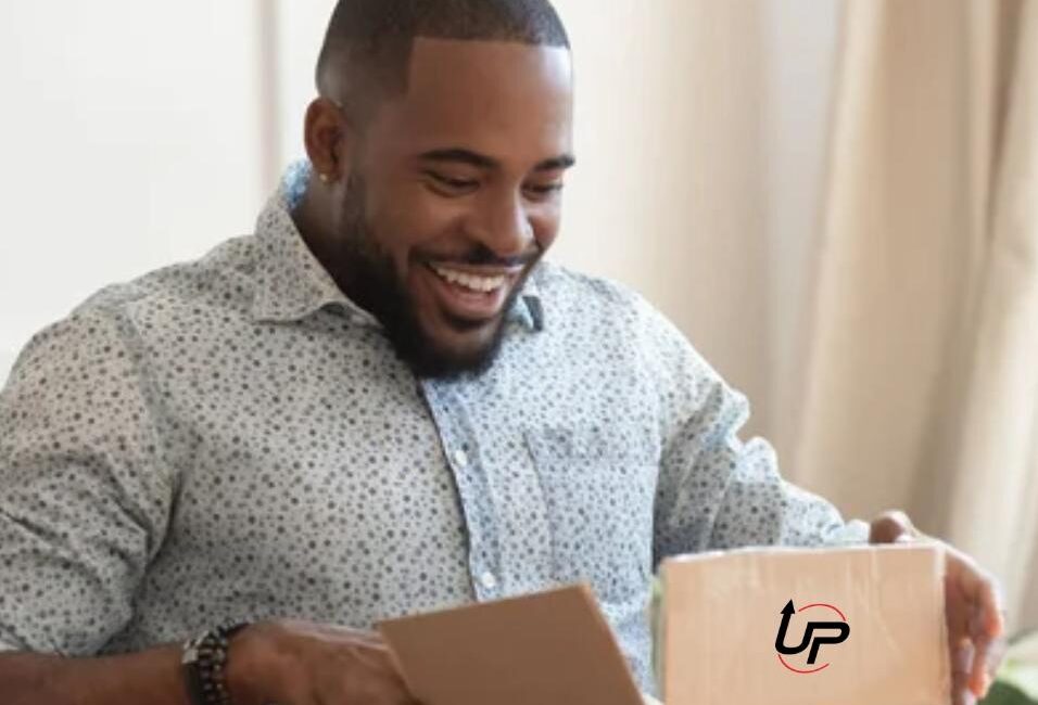 A man opening a box that has the logo for Up Proteins on it.