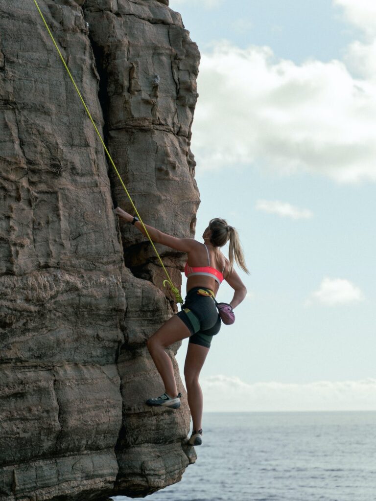 a woman rock climbing outside